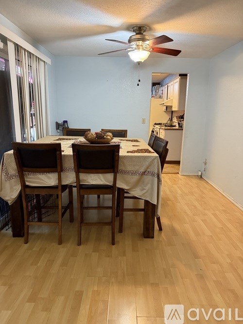 A dining room with a table set for two.