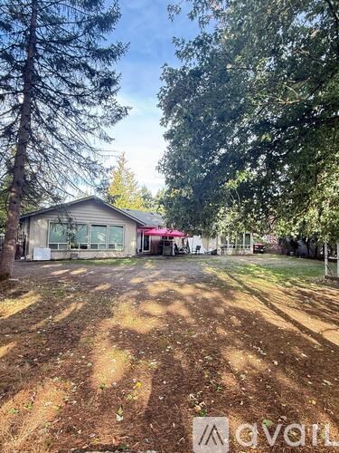 A hallway with a wooden door and a light on the ceiling.