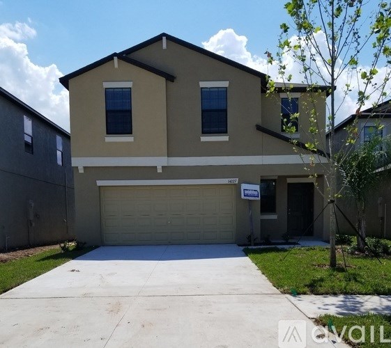 A two-story house with a garage is for sale.