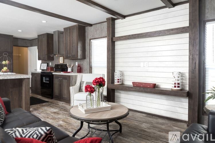 A modern kitchen with dark wood cabinets and a black oven.