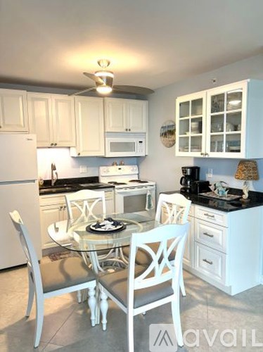 Two black elevators in a hallway with a logo on the wall.