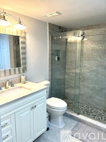 A white toilet sits next to a sink in a bathroom.