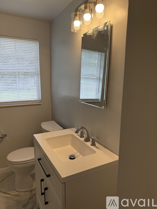 A bathroom with a white toilet and sink.