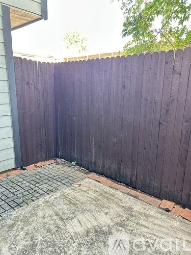 A kitchen with a black stove and white microwave.