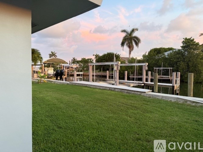 A house with a large lawn and a pool in the backyard.