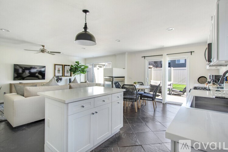 A modern kitchen with white cabinets and a large island.