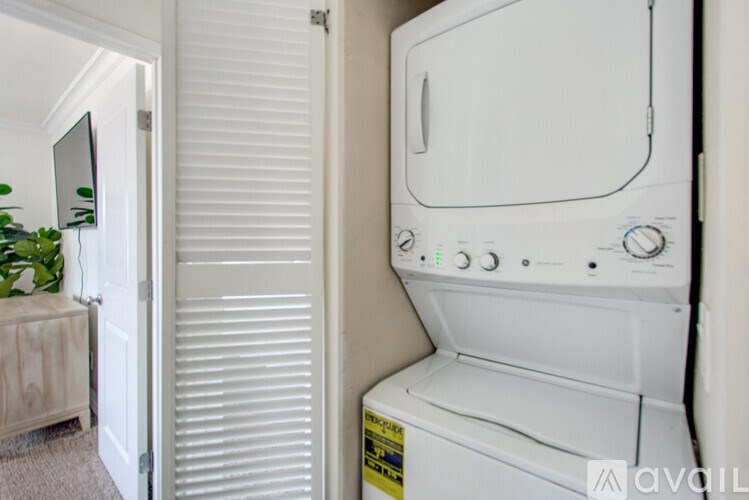 A white washing machine is in a small room.