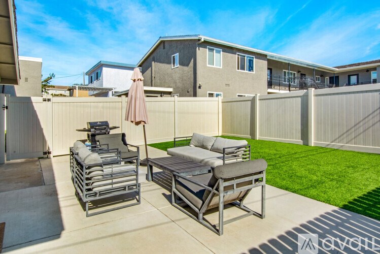A patio with a table and chairs is set up on a sunny day.