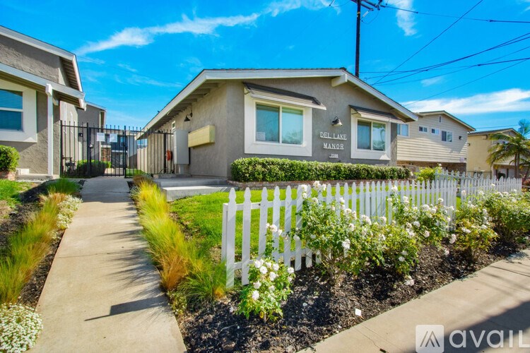 A house with a white picket fence in front of it.
