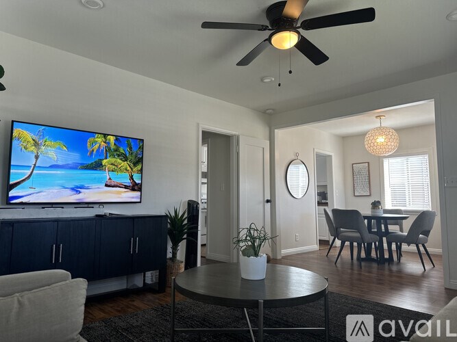 A living room with a television displaying a beach scene.