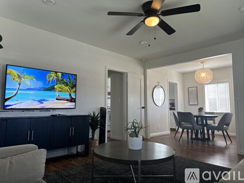 A living room with a television displaying a beach scene.