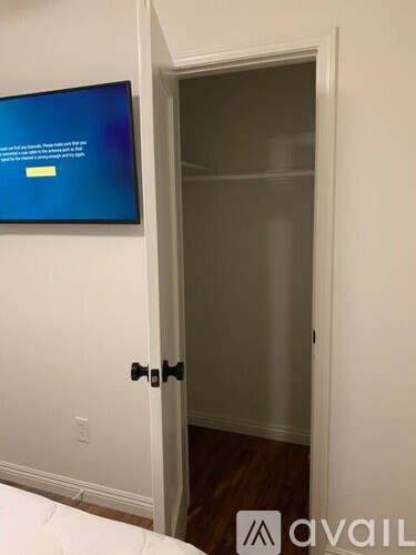 A white door with a black handle is open.