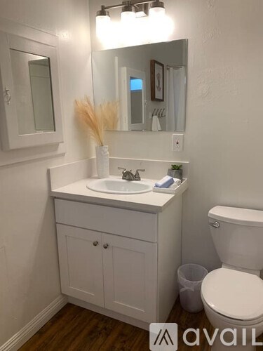 A white bathroom with a toilet and a sink.