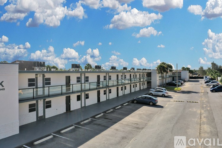 A parking lot with cars and a building with the number 940.