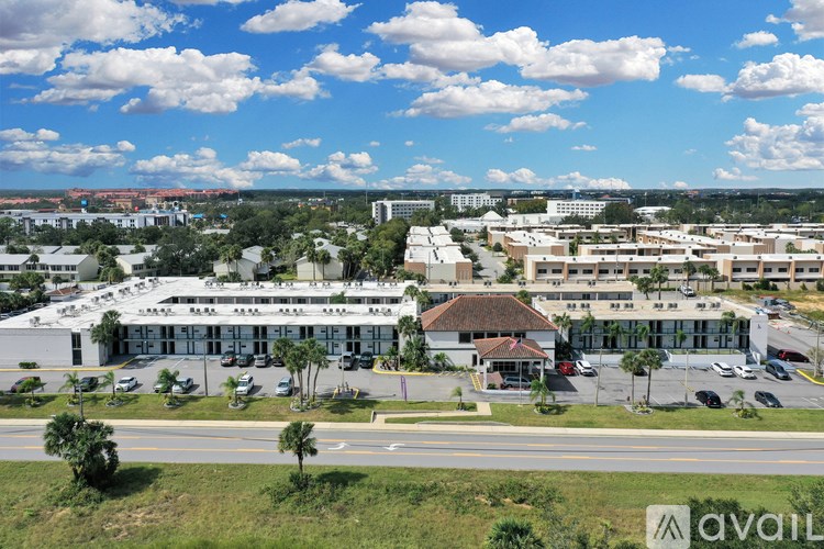 A large building complex with a parking lot in front.