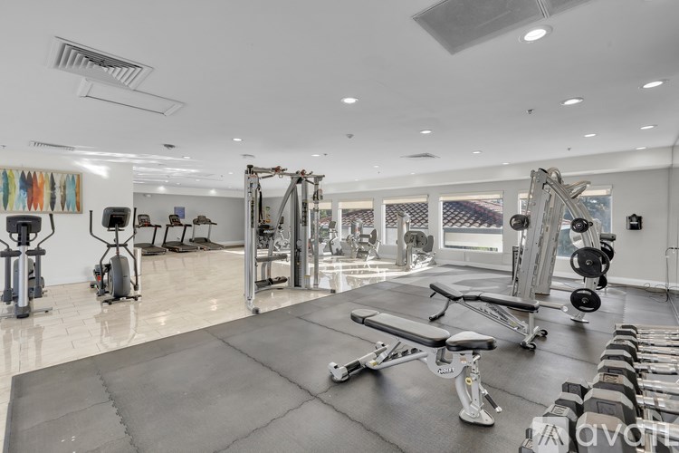 A well-equipped gym with a variety of machines and weights.