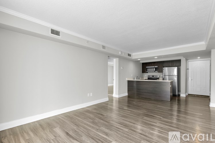 A spacious kitchen with a refrigerator, microwave, and oven.