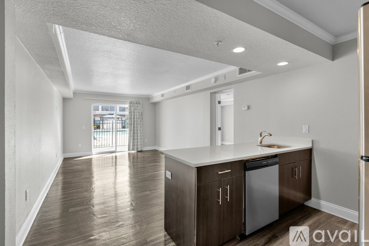 A kitchen with wooden floors and white walls.