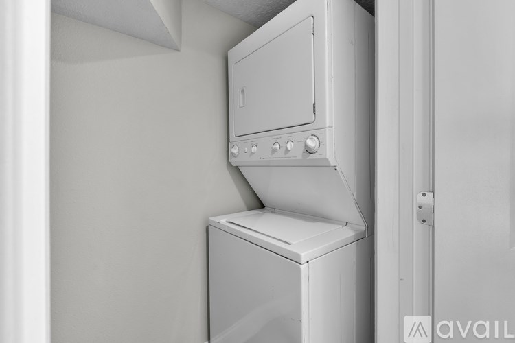A white dishwasher is placed next to a white oven.