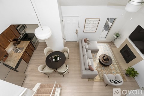 A modern living room with a kitchen area in the background.