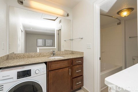 A small laundry room with a washer and dryer.