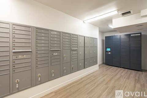 A row of mailboxes are lined up against a wall.