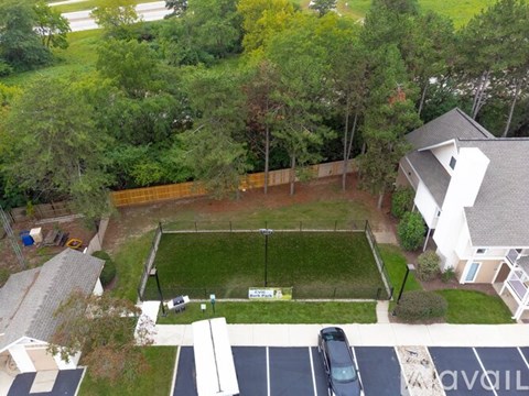 A residential area with a house, a car, and a parked truck.