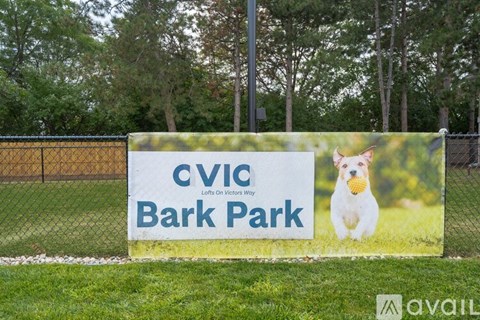 A sign for CVID Bark Park with a dog on it.