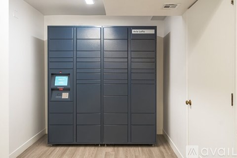 A tall, dark storage unit with a digital keypad on the front.