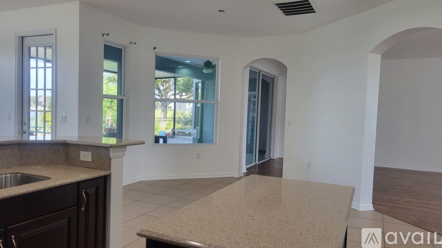 A kitchen with a sink, countertop, and a window.