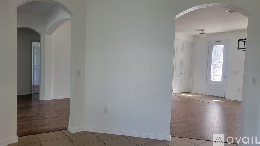A room with white walls and wooden flooring is available for rent.