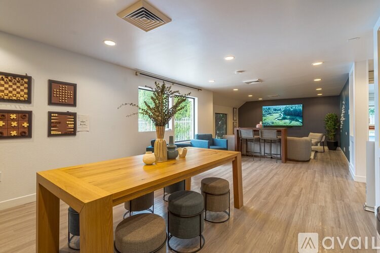 A modern dining room with a wooden table and chairs.