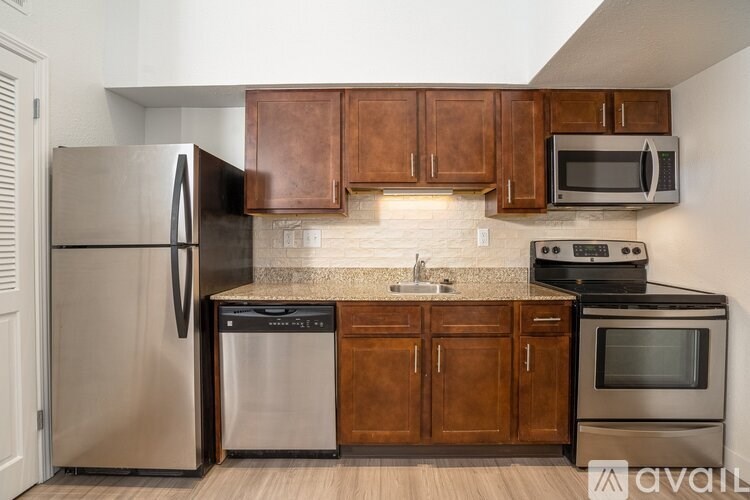 A kitchen with wooden cabinets and stainless steel appliances.