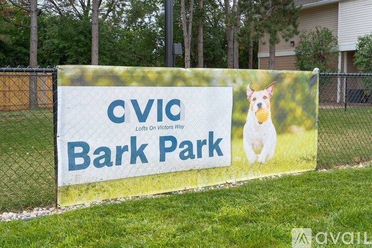 A sign for Cvic Bark Park with a picture of a dog on it.