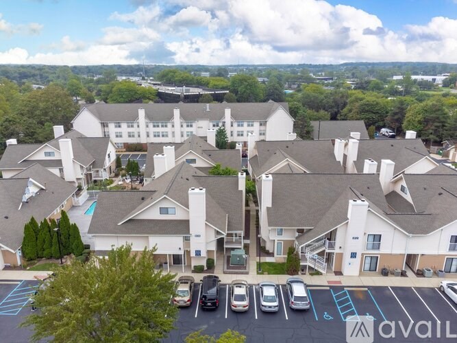 A large white building with a parking lot in front of it.