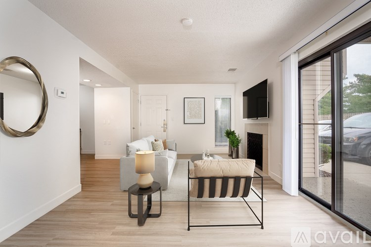 A modern living room with a sofa, a coffee table, and a flat-screen TV.