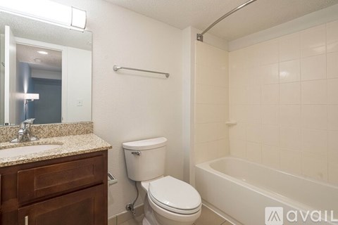 A bathroom with a toilet, sink, and bathtub.