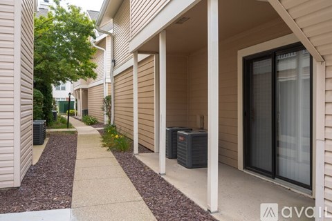 A row of houses with a sidewalk in front.