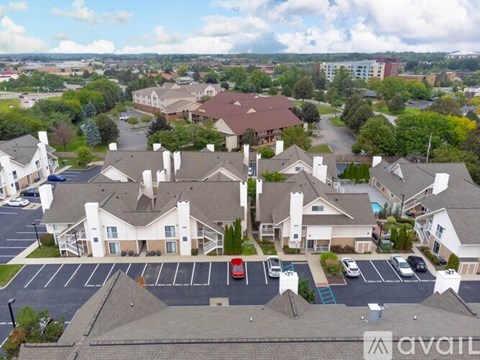 A bird's eye view of a housing complex with a large building in the center.