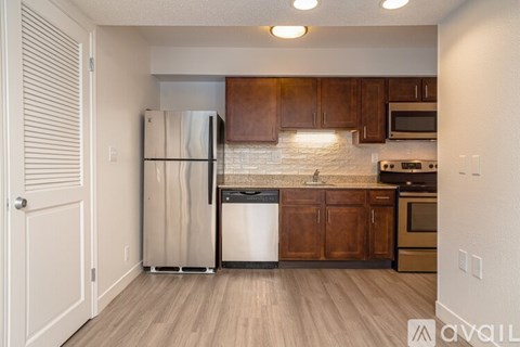 A kitchen with wooden cabinets and a white fridge.