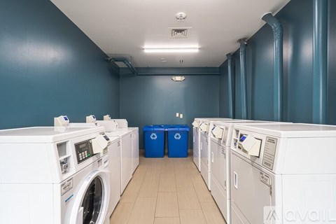 A row of washing machines in a laundromat.
