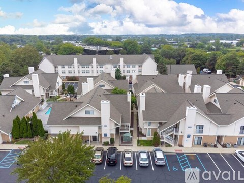 A large white building with a parking lot in front of it.