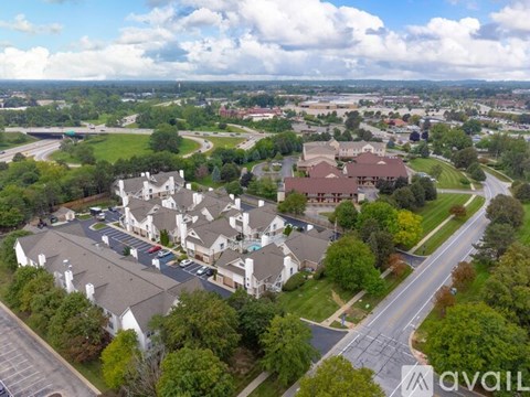 A bird's eye view of a residential area with houses and roads.