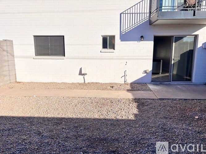 A white building with a balcony and a door.