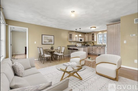 A living room with a couch, chairs, and a coffee table.