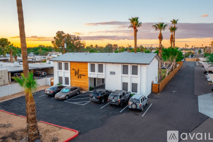 A parking lot with cars and a building with the year 2020 on it.