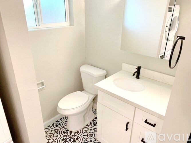A white toilet and sink in a bathroom.