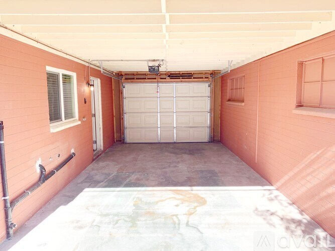 A garage with a white ceiling and a white garage door.