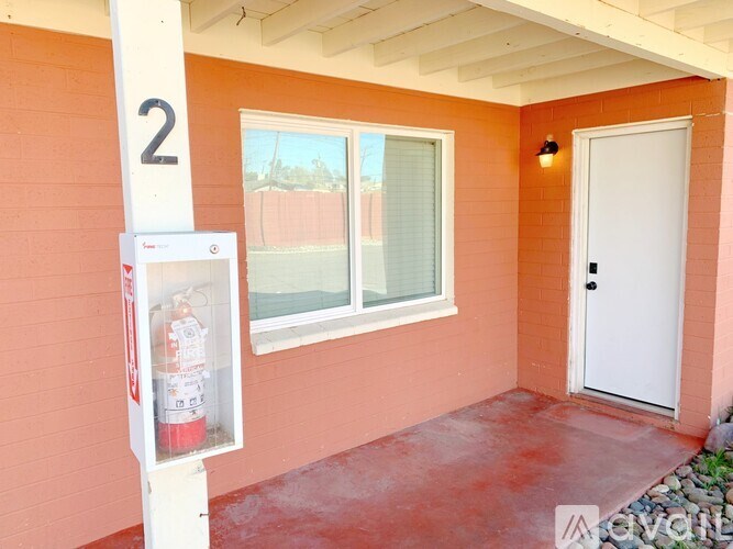 A small orange room with a door and a window.