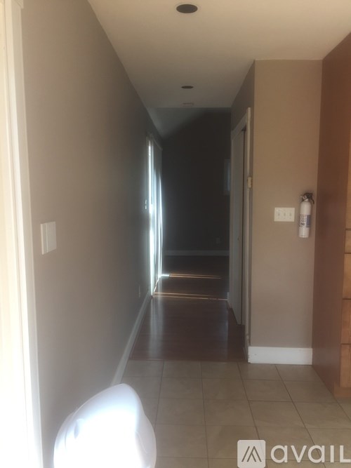 A long hallway with a door at the end.